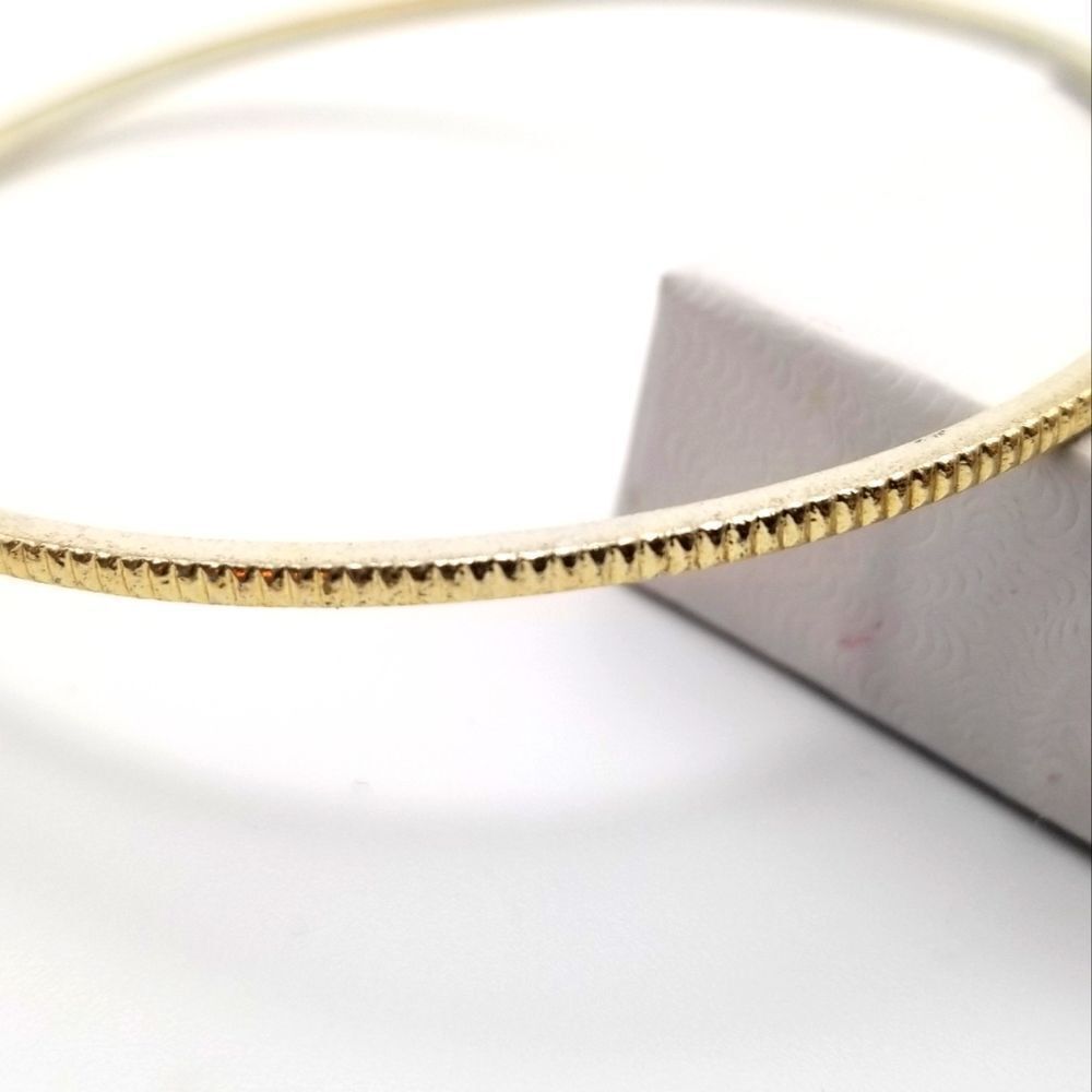 Gold tone etched bumpy road bracelet. B708